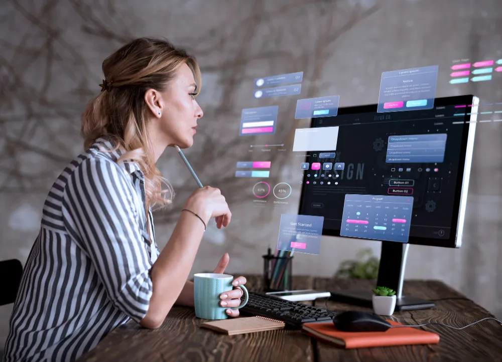 Web developer coding a responsive website on dual monitors